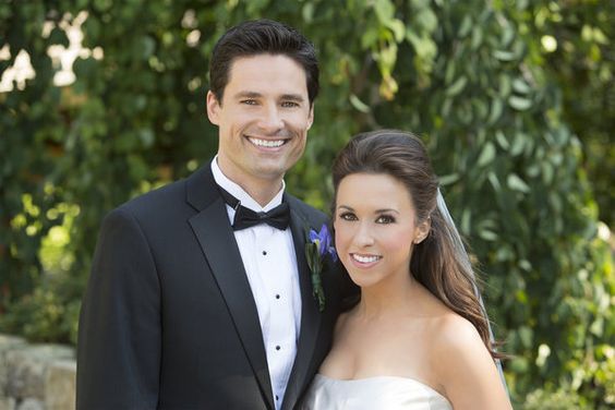 David Nehdar and Lacey Chabert taking a picture after their marriage ceremony.